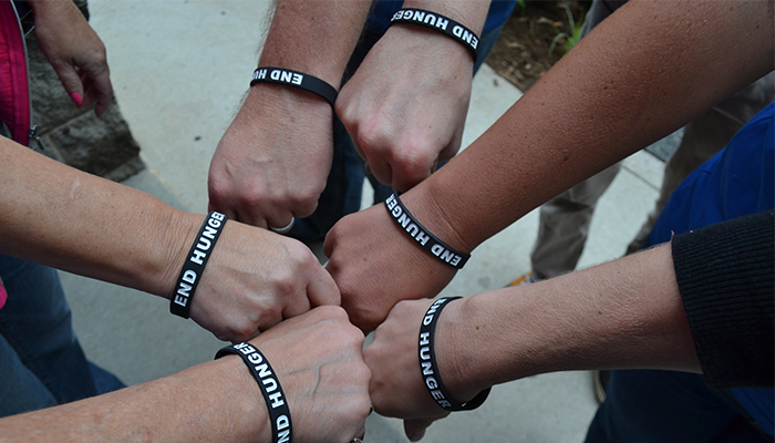 Jackrabbit team members wearing End Hunger bracelets.