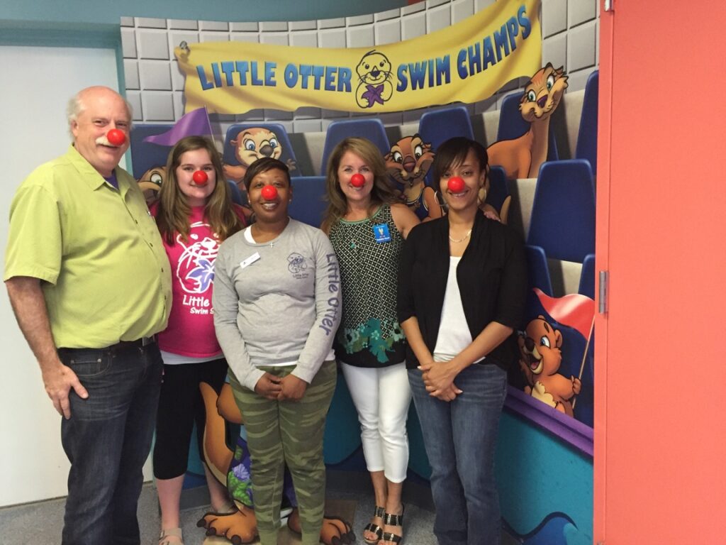 Little Otter Swim Champs staff wearing red noeses