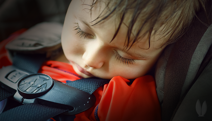 Baby asleep in a hot car.