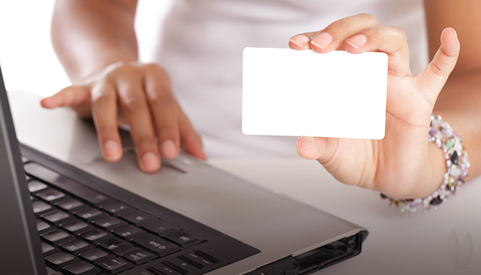 A woman holding a blank gift card.