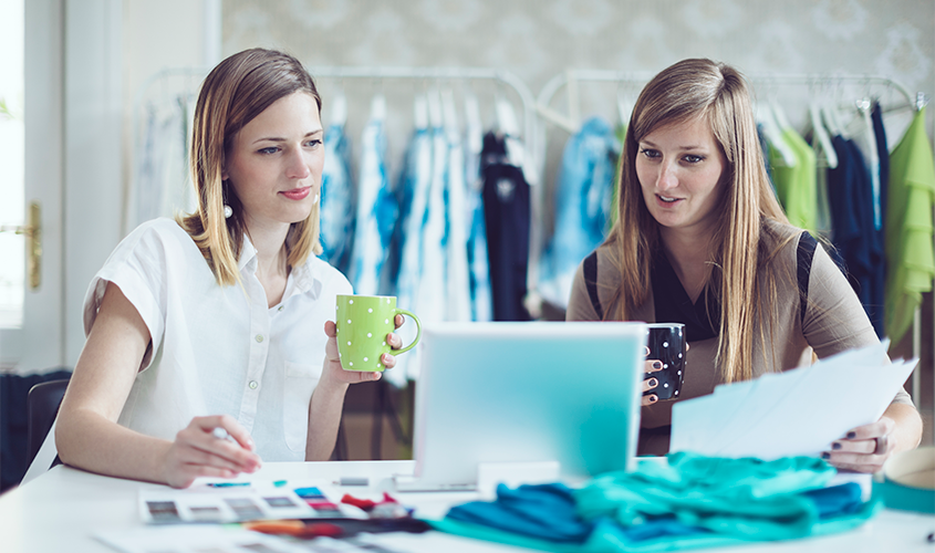 Two dance instructors are doing organization and inventory of the studio dance costumes.