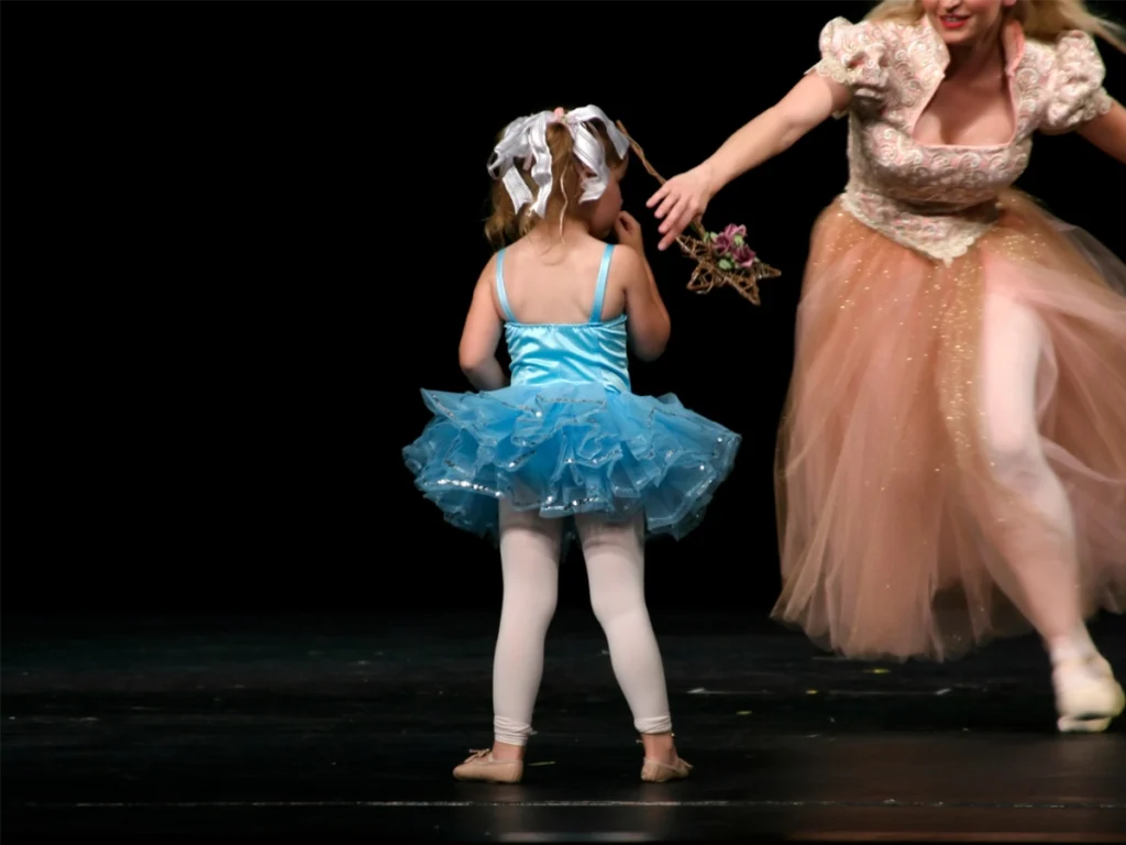 child learning dance routine with teacher