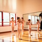 A dance teacher instructs her young students in a routine