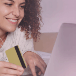 woman-smiling-at-computer-with-card