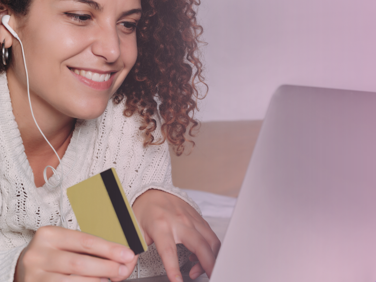 woman-smiling-at-computer-with-card